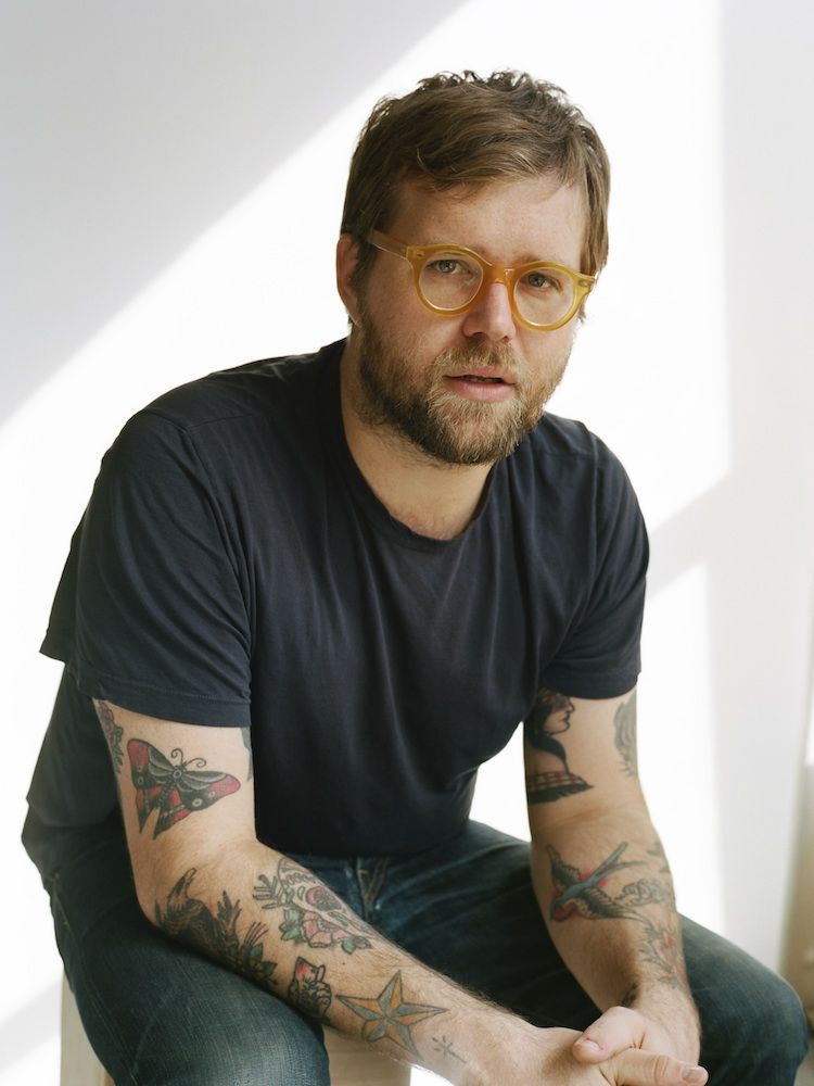 Portrait of James Thompson with his professional gardening tools